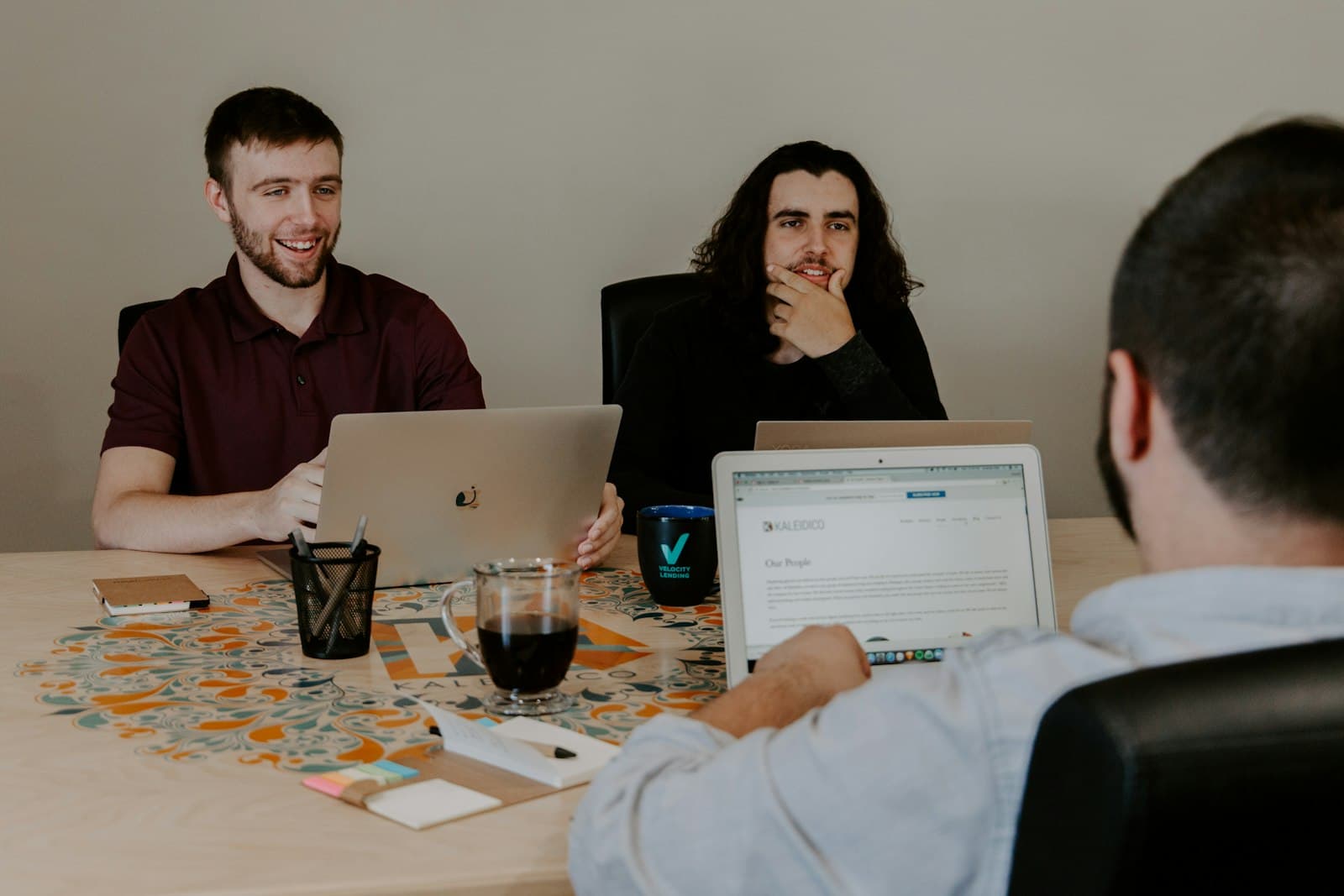 Startup team meeting around laptops